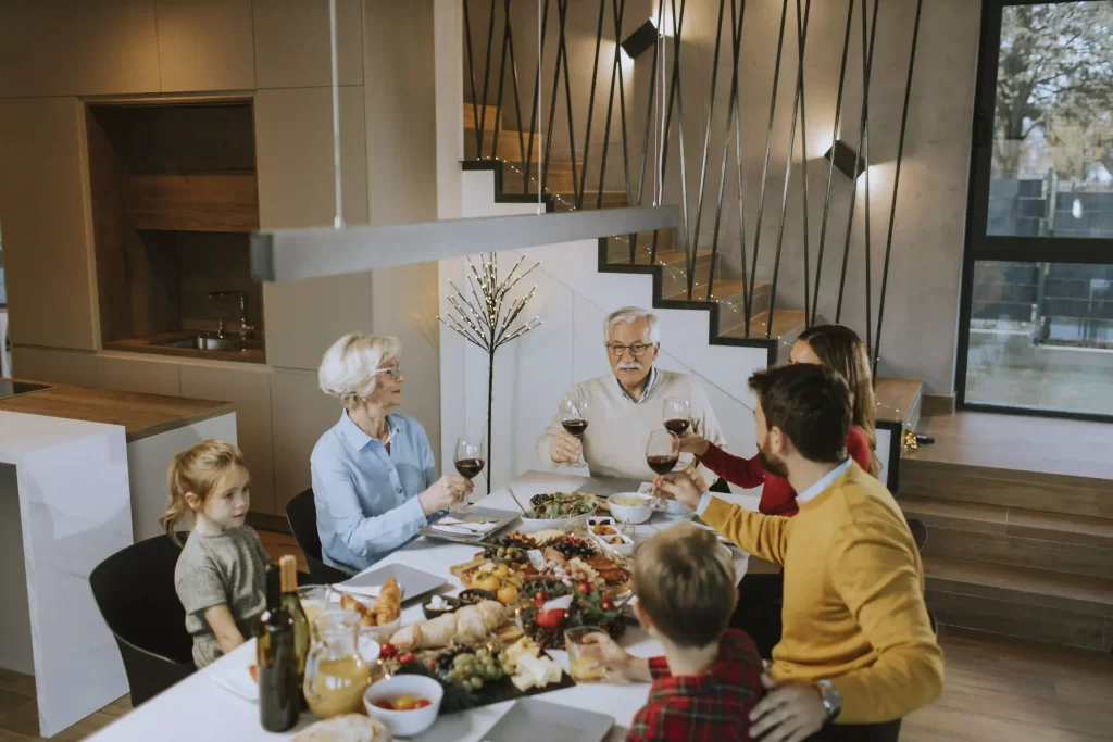 Family enjoying Thanksgiving meal in new home.